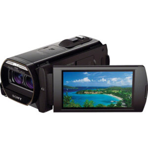 Videocámara Sony HDR-TD30V negra con pantalla LCD desplegada mostrando una playa tropical.