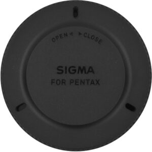 Tapa de cuerpo Sigma negra para montura Pentax, con indicaciones de apertura y cierre.