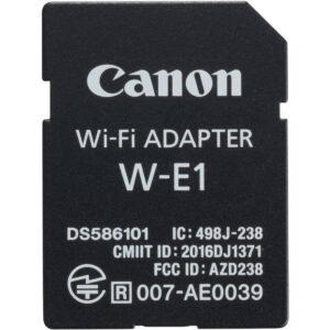 Adaptador Wi-Fi Canon W-E1 negro con logo Canon, número de modelo y certificaciones.